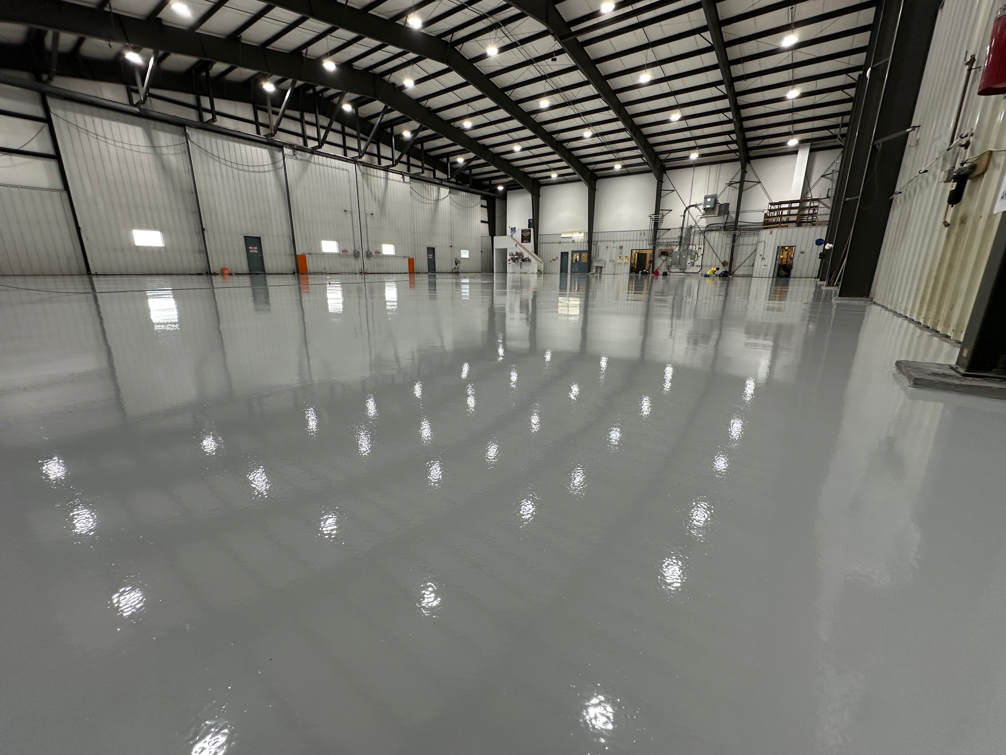 Large industrial facility with a glossy grey epoxy floor